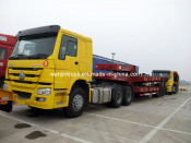 HOWO Tractor Truck Hauling Low-Bed Trailer