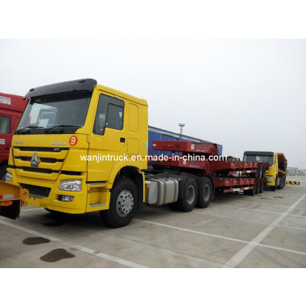 HOWO Tractor Truck Hauling Low-Bed Trailer